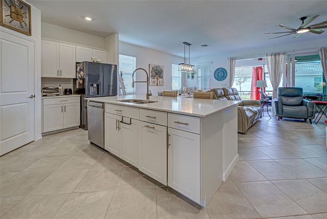 kitchen with white cabinets, sink, an island with sink, and stainless steel dishwasher