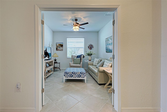 living room featuring ceiling fan and light tile patterned flooring