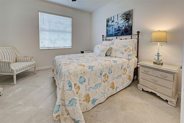 tiled bedroom featuring ceiling fan