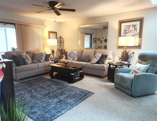 carpeted living room with ceiling fan and a textured ceiling