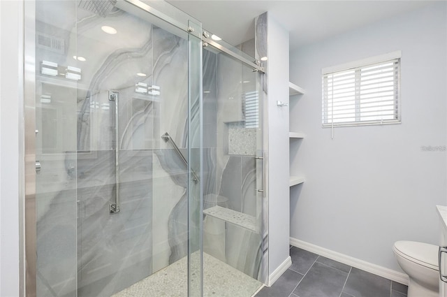 bathroom with tile patterned floors, toilet, and walk in shower