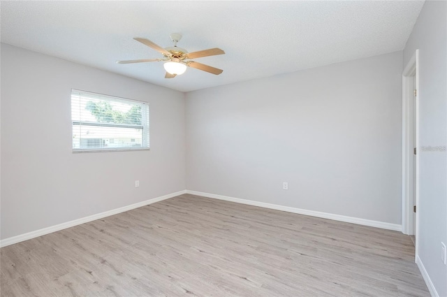 unfurnished room featuring ceiling fan, light hardwood / wood-style floors, and a textured ceiling