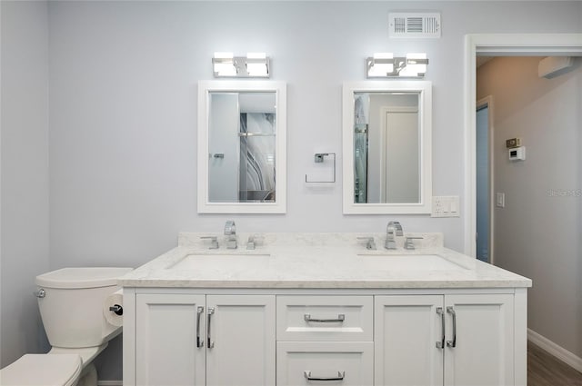 bathroom featuring hardwood / wood-style floors, vanity, and toilet