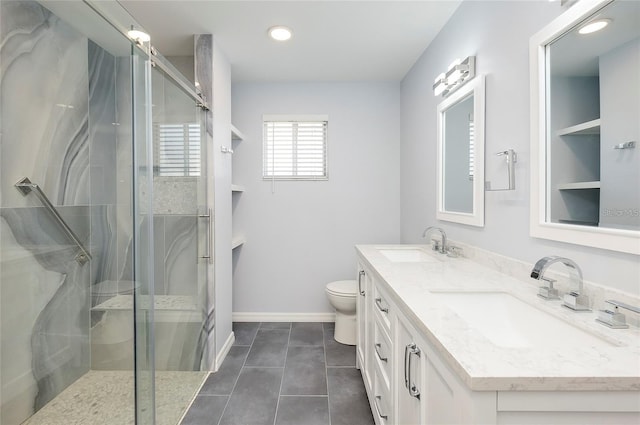 bathroom featuring tile patterned flooring, vanity, toilet, and a shower with shower door