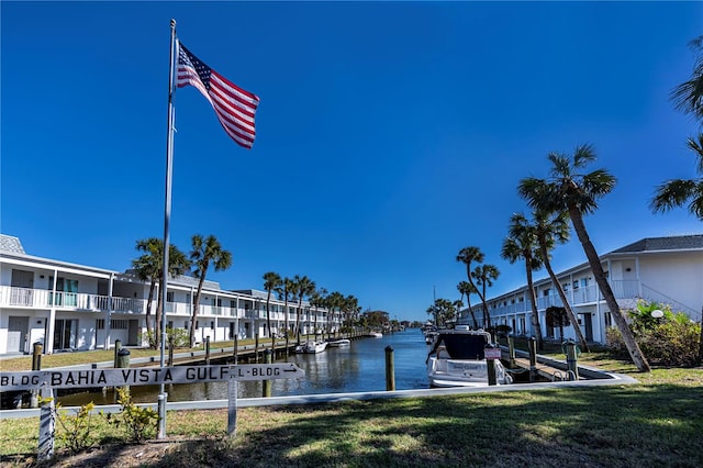 dock area with a yard and a water view