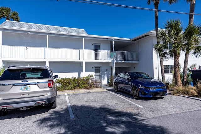 view of building exterior with uncovered parking