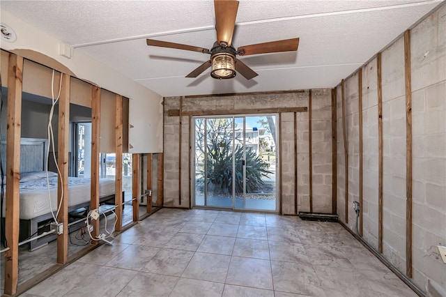 unfurnished room featuring a textured ceiling and ceiling fan