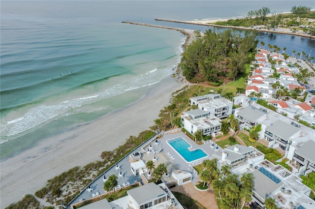 birds eye view of property featuring a beach view and a water view