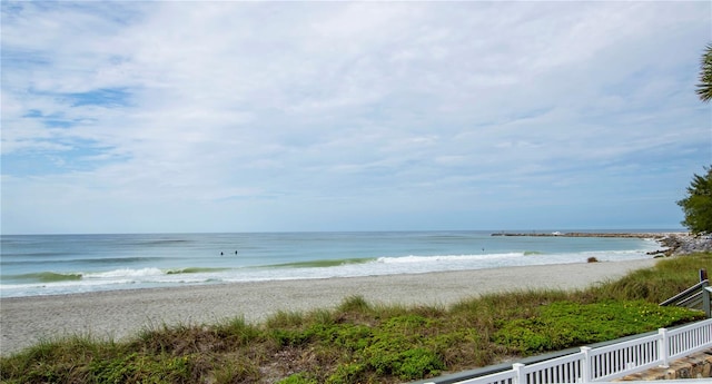 property view of water with fence and a beach view