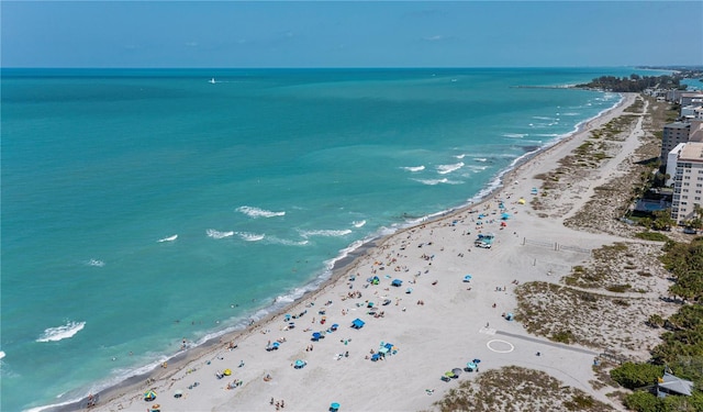 drone / aerial view featuring a view of the beach and a water view