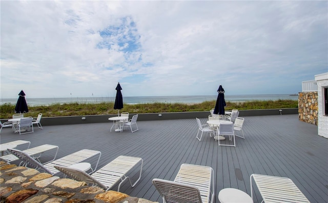 exterior space featuring outdoor dining area and a water view