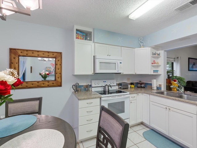 kitchen featuring white cabinets, sink, white appliances, and a textured ceiling