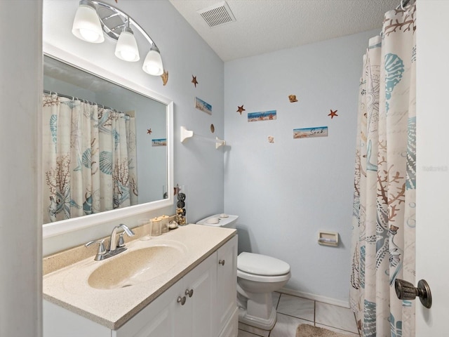 bathroom with tile patterned flooring, vanity, a textured ceiling, and toilet