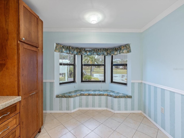 empty room featuring ornamental molding and light tile patterned floors