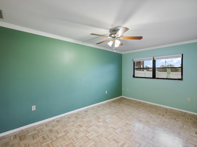 spare room with crown molding, light parquet flooring, and ceiling fan