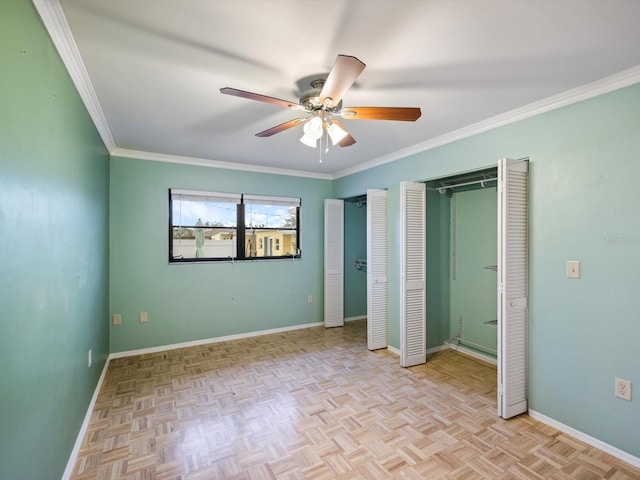 unfurnished bedroom featuring light parquet flooring, two closets, ceiling fan, and crown molding