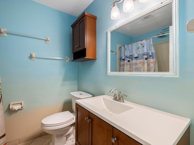 bathroom with tile patterned floors, vanity, a shower with shower curtain, and toilet