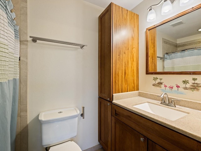 bathroom with vanity, toilet, and curtained shower