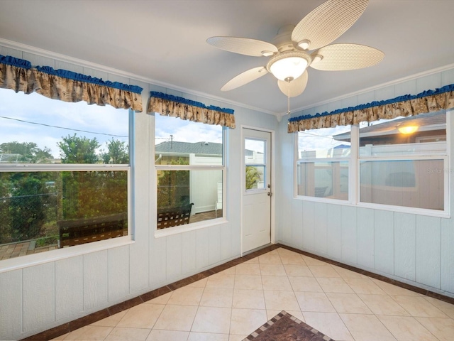 unfurnished sunroom featuring ceiling fan