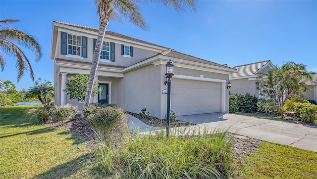 view of front of home with a garage and a front lawn