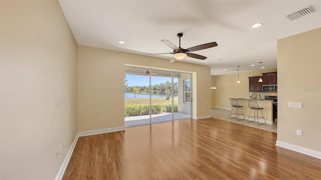 interior space with ceiling fan and light wood-type flooring