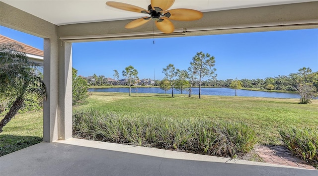 exterior space with a water view and ceiling fan