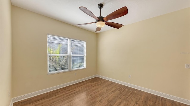 unfurnished room with hardwood / wood-style flooring and ceiling fan