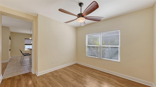 empty room featuring ceiling fan and light hardwood / wood-style flooring