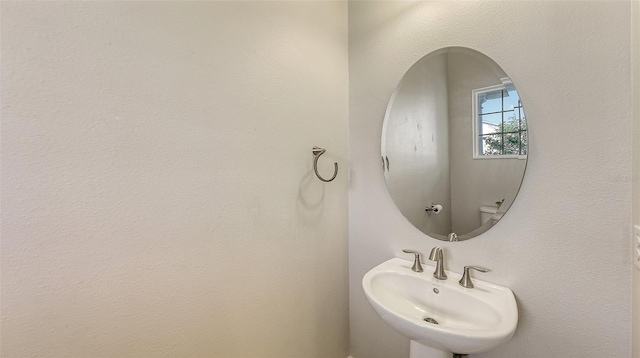 bathroom featuring toilet and sink