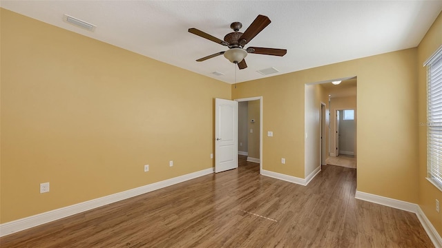 interior space featuring hardwood / wood-style flooring, ceiling fan, and a healthy amount of sunlight