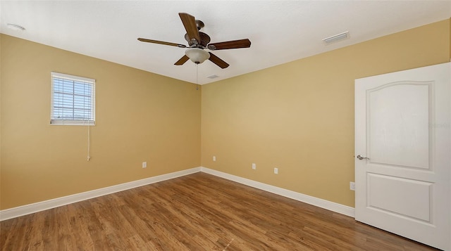 spare room featuring hardwood / wood-style floors and ceiling fan