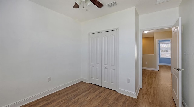 unfurnished bedroom featuring light hardwood / wood-style flooring, a closet, and ceiling fan