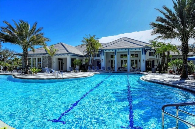 view of pool featuring ceiling fan, french doors, and a patio