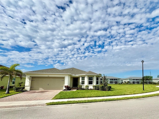 view of front of home featuring a garage and a front lawn