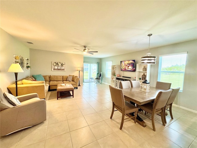 tiled dining space featuring ceiling fan