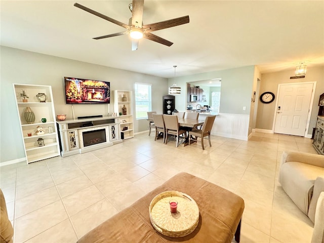 living room with ceiling fan and light tile patterned floors