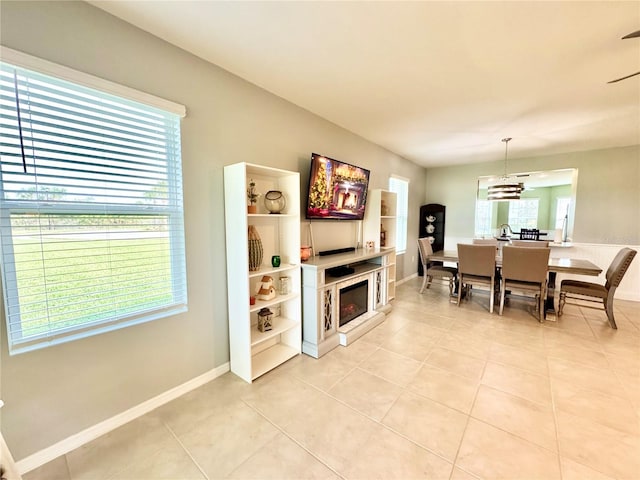 dining room with plenty of natural light, light tile patterned flooring, and a notable chandelier