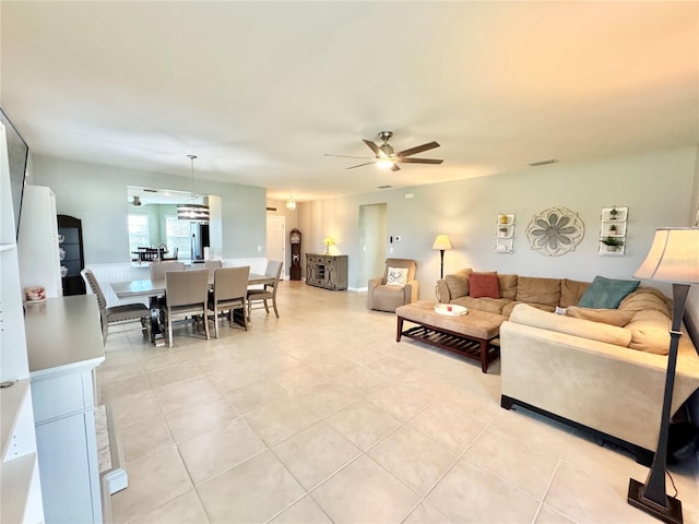 living room with light tile patterned floors and ceiling fan