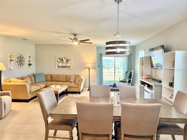 tiled dining area with ceiling fan with notable chandelier