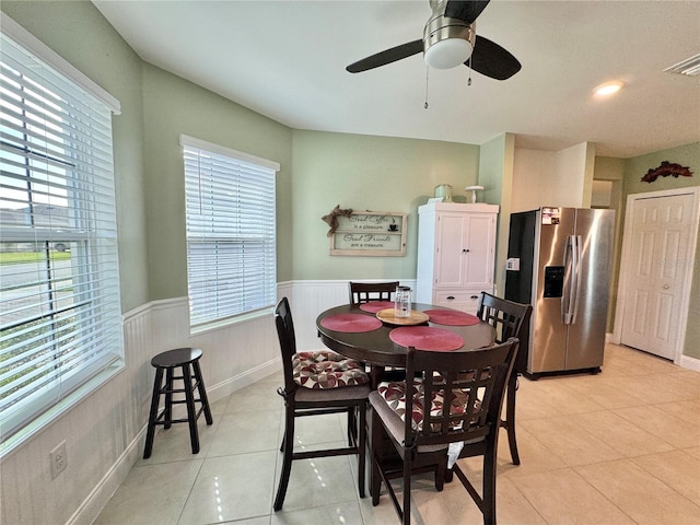 dining room with light tile patterned flooring, a wealth of natural light, and ceiling fan