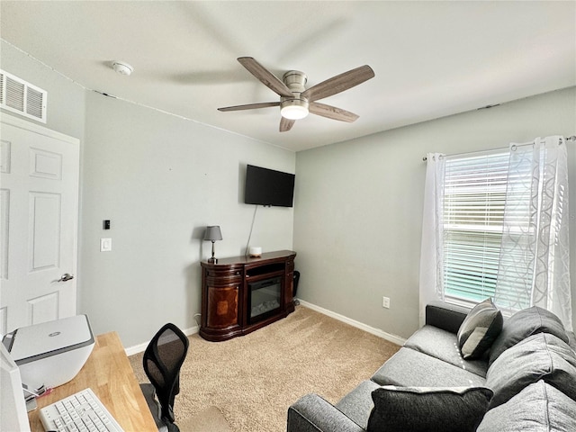 carpeted living room with ceiling fan