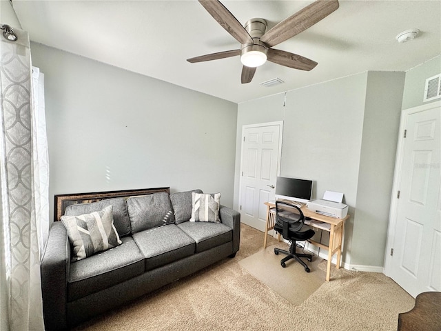 office space featuring light carpet and ceiling fan