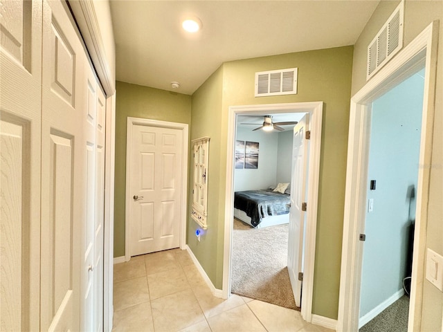 hallway featuring light carpet