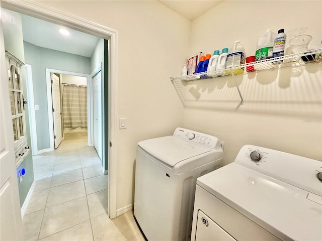 washroom with light tile patterned flooring and washing machine and clothes dryer