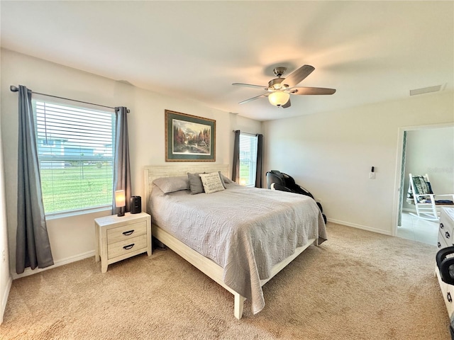 bedroom with light carpet and ceiling fan