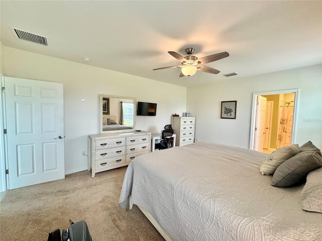 bedroom with connected bathroom, ceiling fan, and light colored carpet