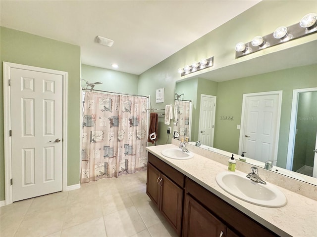 bathroom featuring vanity, tile patterned floors, and walk in shower