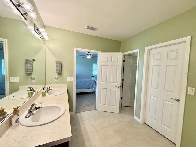 bathroom with tile patterned floors, vanity, and ceiling fan