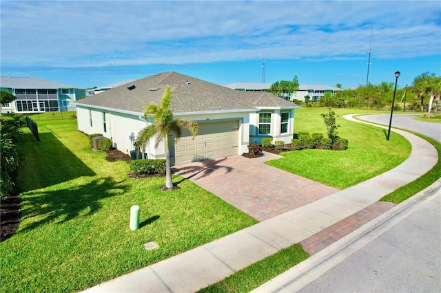 view of front of home with a garage and a front lawn