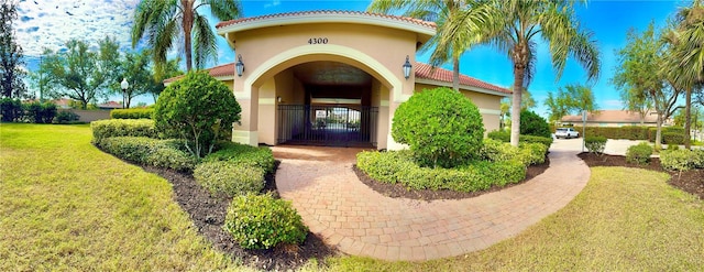 view of exterior entry with a yard